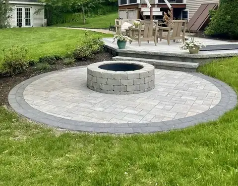 Round paver fire pit circle on a lawn
