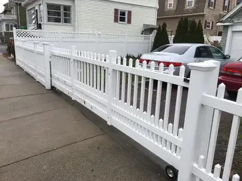 White picket fence along a sidewalk