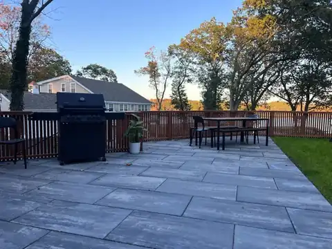 Blue stone patio with grill and outdoor dining