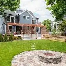 Backyard after the renovation with fire pit and fencing