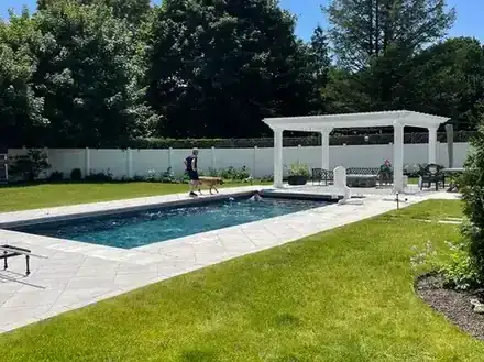 Backyard pool with paver deck after the renovation