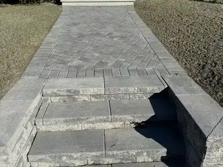 Stone steps and retaining wall along the walkway