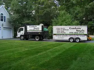 A Gardenin’ Angels truck parked beside a freshly striped lawn